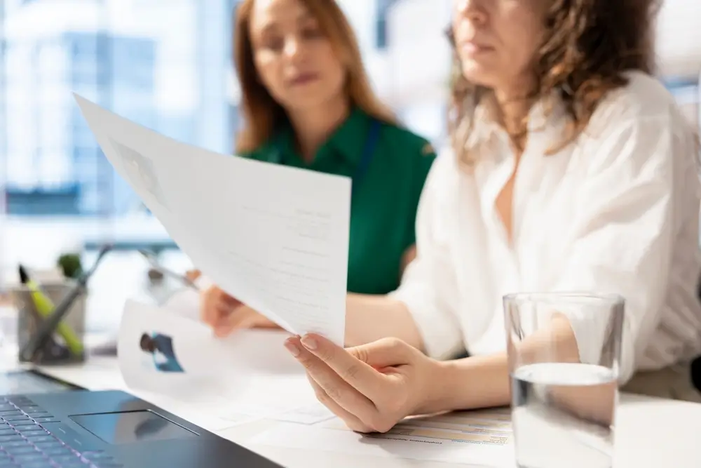 Recruitment team reviewing candidate profile and assessment output at a computer during the hiring process.