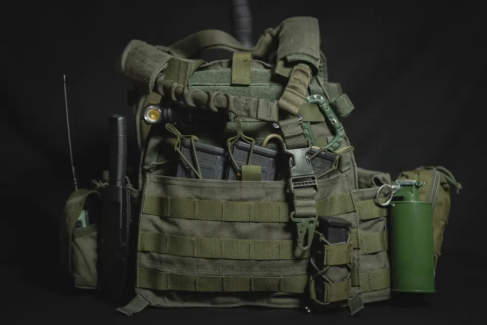 Tactical vest with rifle magazines, a knife, and military equipment army gear displayed for NZDF personnel.